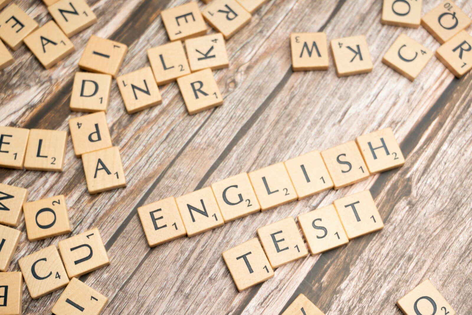 a close up of scrabble letters on a wooden surface